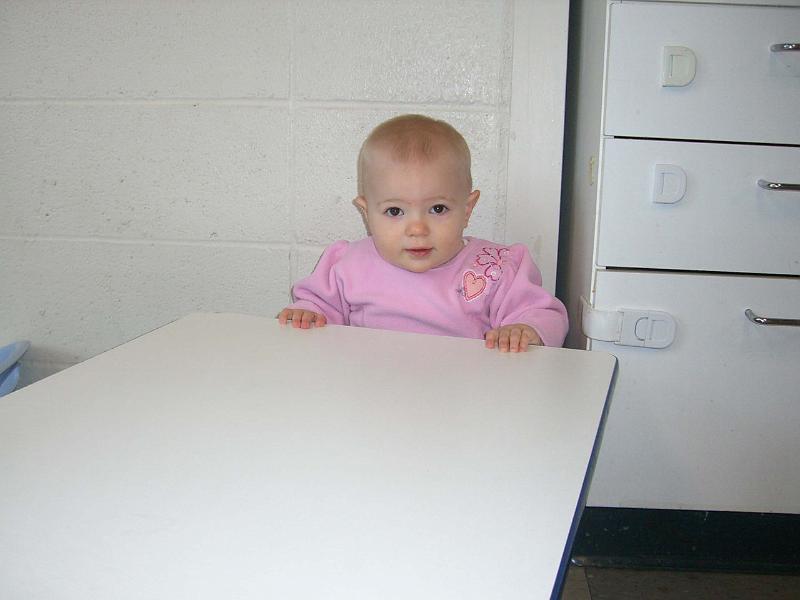 CIMG2586.jpg - She arrives at daycare and immediately seats herself for snack and even pulls the table up to her belly.